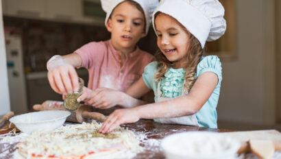 boy and girl cooking pizza.