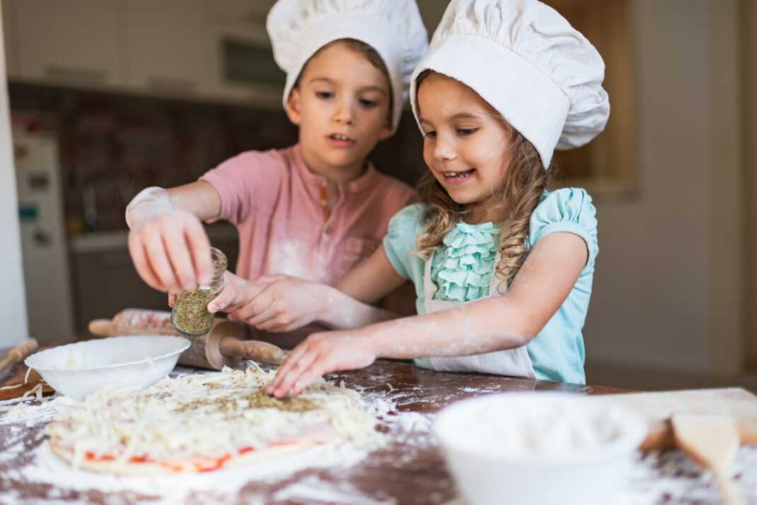 boy and girl cooking pizza.